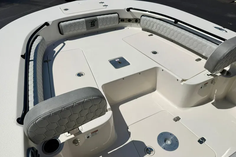 Slide: The Image of 2026 Carolina Skiff 22 Ultra Elite boat interior with cushioned seating and storage compartments. - 12