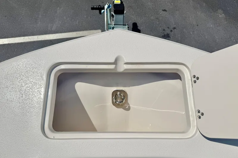 Slide: The Image of Storage compartment on 2026 Carolina Skiff 22 Ultra Elite boat, open lid view. - 14