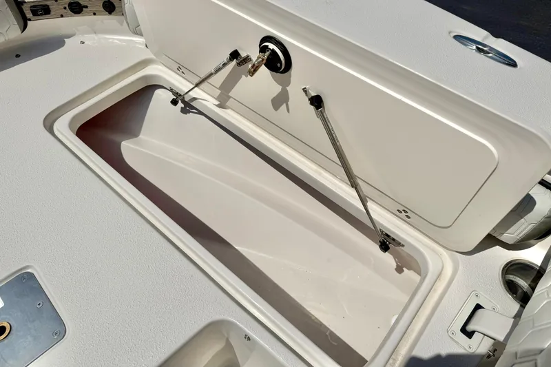 Slide: The Image of Open storage compartment on 2026 Carolina Skiff 22 Ultra Elite boat deck. - 15