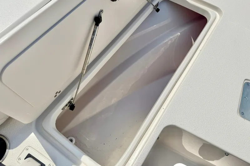 Slide: The Image of Open storage compartment on 2026 Carolina Skiff 22 Ultra Elite boat. - 17