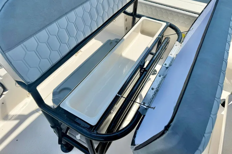 Slide: The Image of 2026 Carolina Skiff 22 Ultra Elite boat seat with storage compartment open. - 23