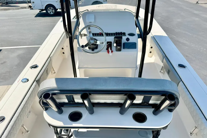 Slide: The Image of 2026 Carolina Skiff 22 Ultra Elite boat interior with steering console and rod holders. - 25
