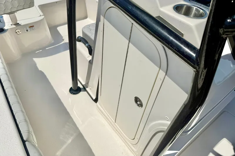 Slide: The Image of 2026 Carolina Skiff 22 Ultra Elite boat interior with storage compartment and cup holder. - 28