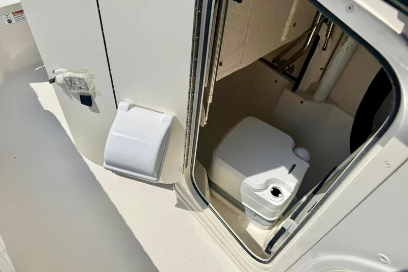 Slide: The Image of 2026 Carolina Skiff 22 Ultra Elite boat interior with portable toilet. - 29