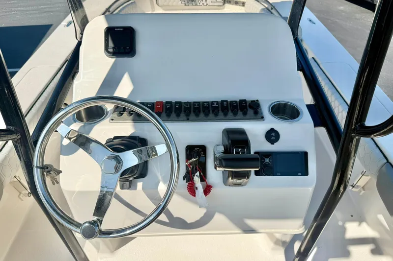 Slide: The Image of 2026 Carolina Skiff 22 Ultra Elite boat console with steering wheel and controls. - 3