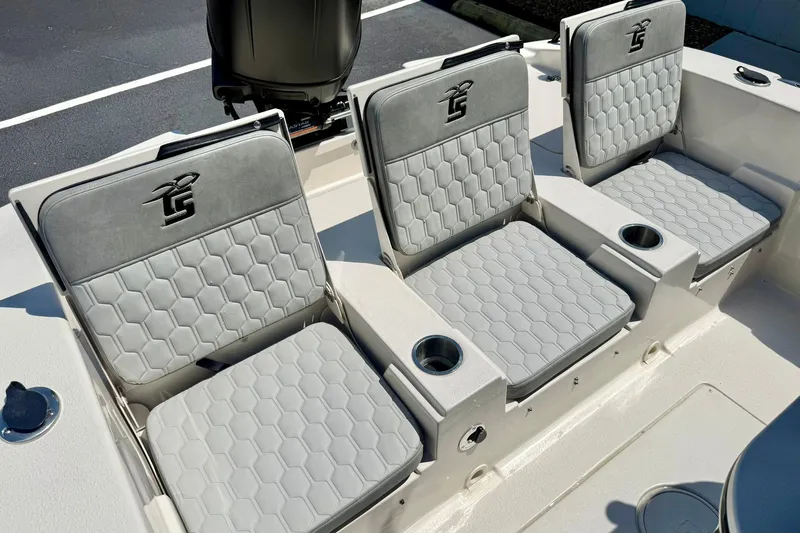 Slide: The Image of 2026 Carolina Skiff 22 Ultra Elite boat seats with cup holders, featuring stylish gray upholstery. - 30
