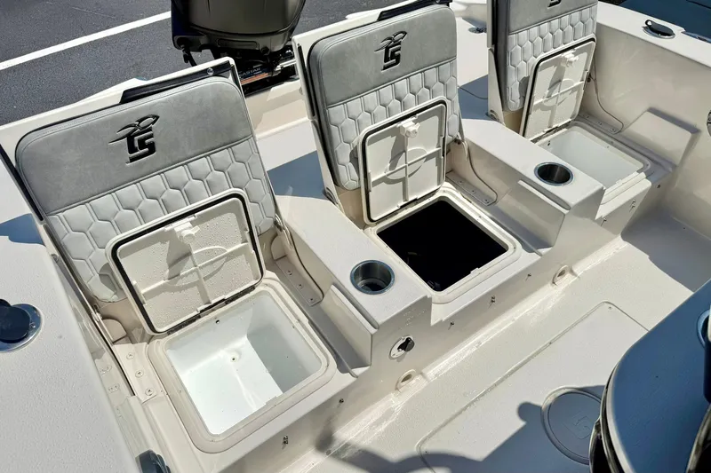 Slide: The Image of 2026 Carolina Skiff 22 Ultra Elite boat seats with storage compartments and cup holders. - 31