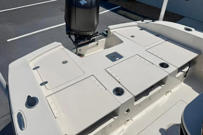 Slide: The Image of 2026 Carolina Skiff 22 Ultra Elite boat deck with storage compartments and motor. - 32