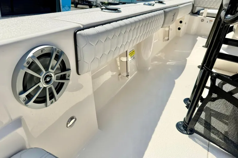 Slide: The Image of 2026 Carolina Skiff 22 Ultra Elite boat interior with speaker and cushioned seating. - 36