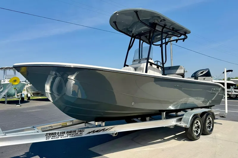 Slide: The Image of 2026 Carolina Skiff 22 Ultra Elite boat on trailer, displayed outdoors under clear sky. - 5