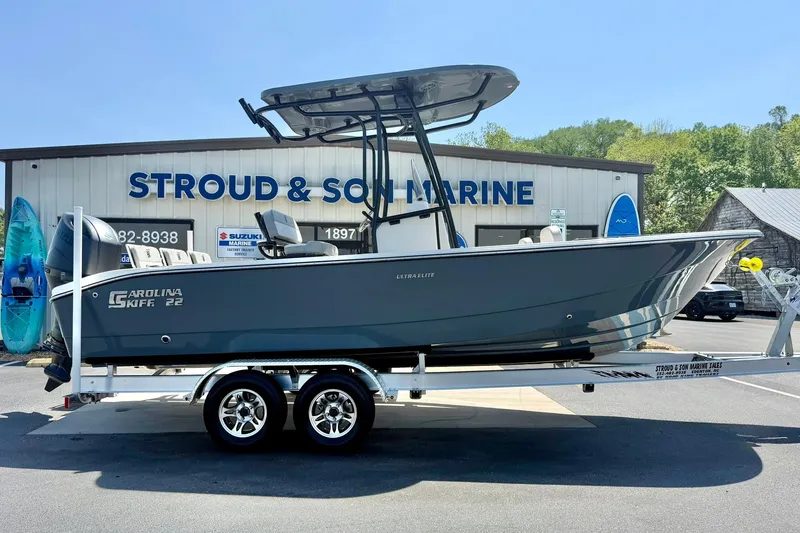 Slide: The Image of 2026 Carolina Skiff 22 Ultra Elite boat on trailer at Stroud & Son Marine dealership. - 7
