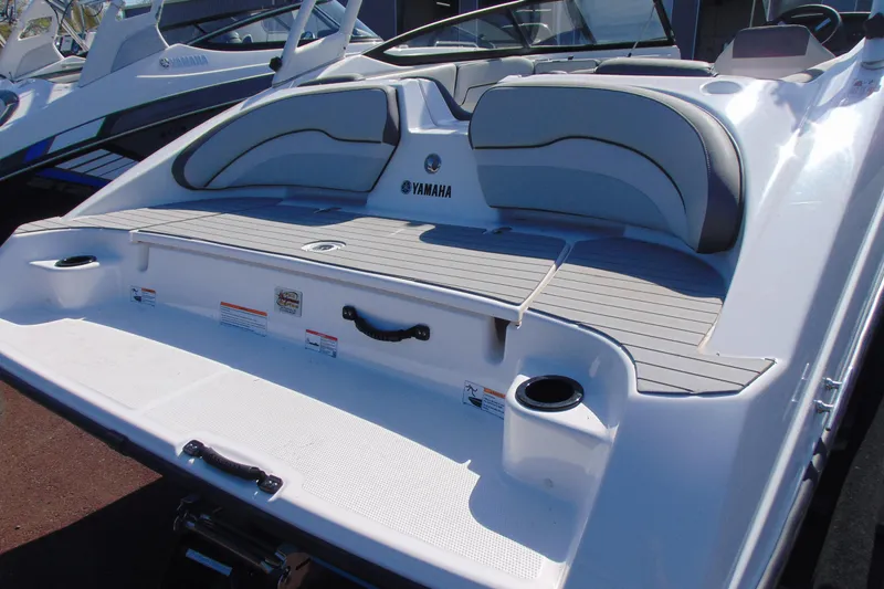 Slide: The Image of 2024 Yamaha Boats AR190 rear deck with seating and cup holders. - 4