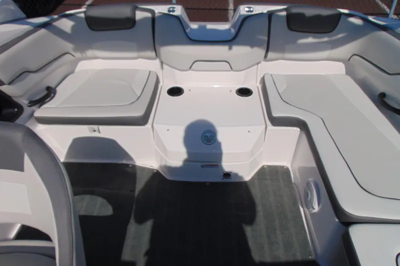 Slide: The Image of 2024 Yamaha Boats AR190 interior seating area with cushioned seats and cup holders. - 8