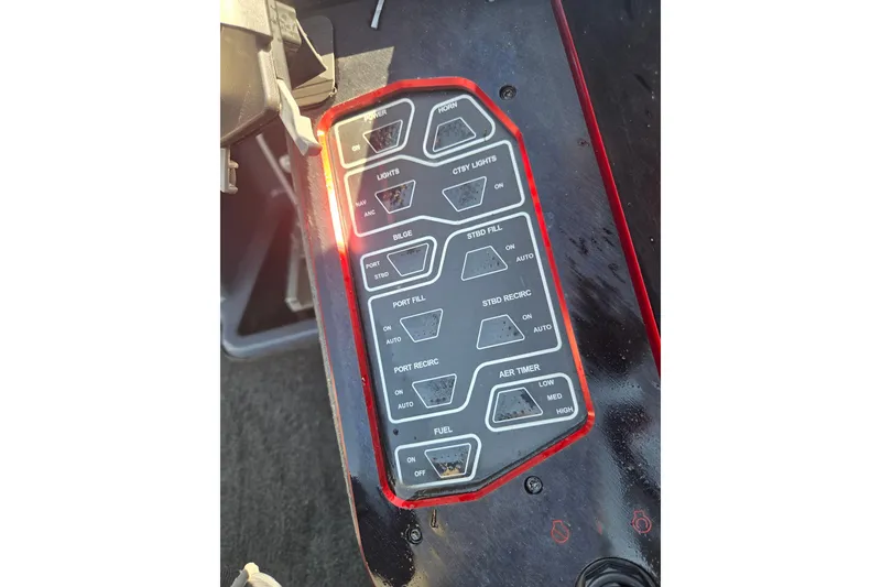 Slide: The Image of Control panel of a 2019 Skeeter FX21 Apex boat with various switches and settings. - 12