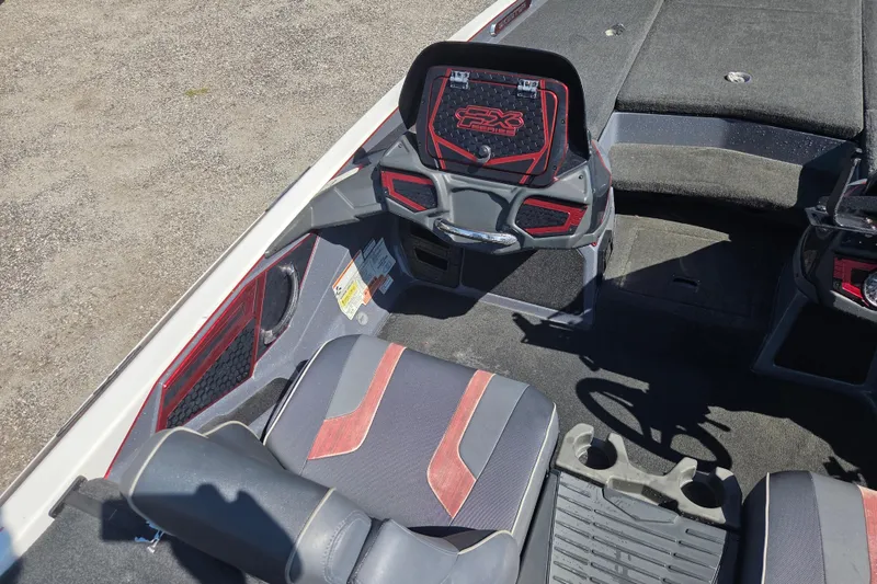 Slide: The Image of 2019 Skeeter FX21 Apex boat interior with red and gray seating and dashboard. - 16