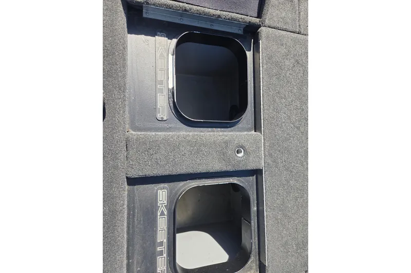 Slide: The Image of 2019 Skeeter FX21 Apex boat storage compartments with carpeted finish. - 20