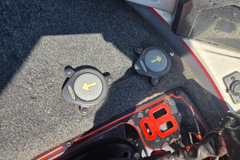 Slide: The Image of 2019 Skeeter FX21 Apex boat foot pedal controls on carpeted deck. - 23