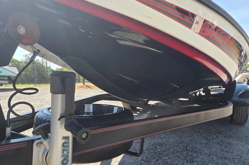 Slide: The Image of 2019 Skeeter FX21 Apex boat on trailer, close-up view of hull and trailer components. - 5