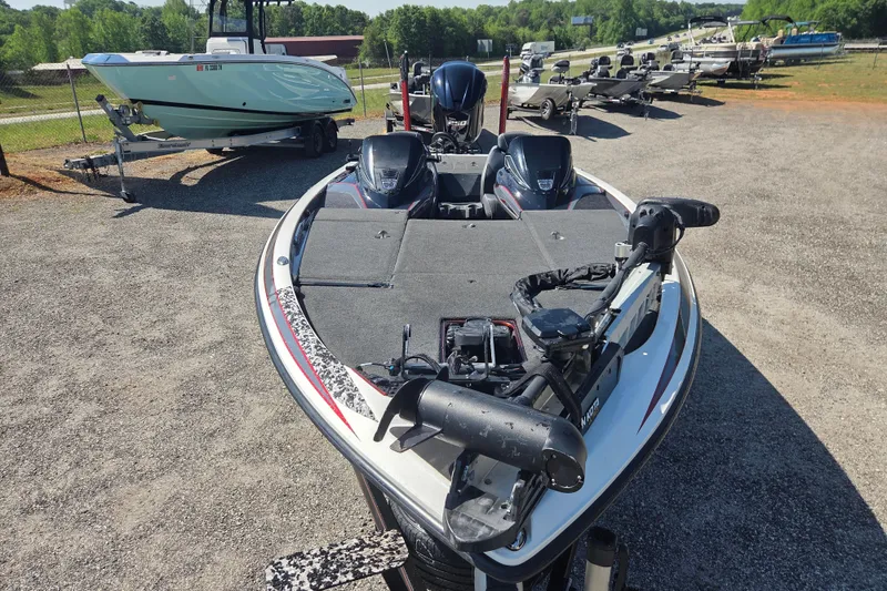 Slide: The Image of 2019 Skeeter FX21 Apex bass boat parked on gravel lot with other boats. - 6
