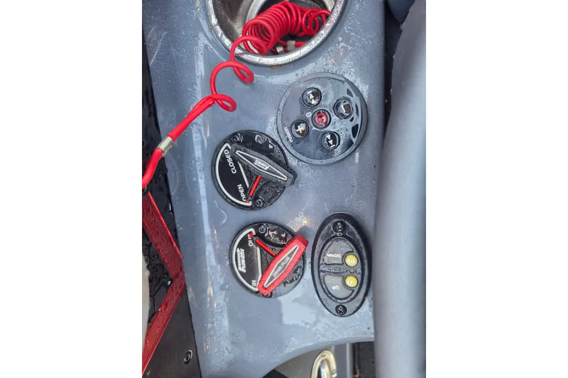 Slide: The Image of Control panel of a 2019 Skeeter FX21 Apex boat with switches and red safety cord. - 9