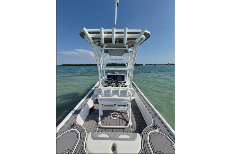 Slide: The Image of 2023 Turner Boatworks 2500VS on calm water, showcasing helm and seating area. - 14