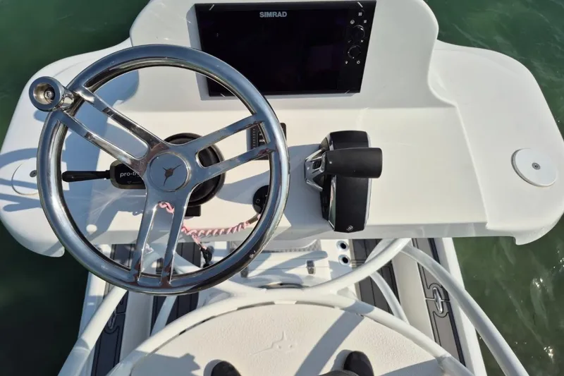Slide: The Image of Steering console of 2023 Turner Boatworks 2500VS with Simrad display and controls. - 4