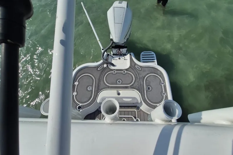 Slide: The Image of Overhead view of 2023 Turner Boatworks 2500VS deck and motor in clear water. - 6
