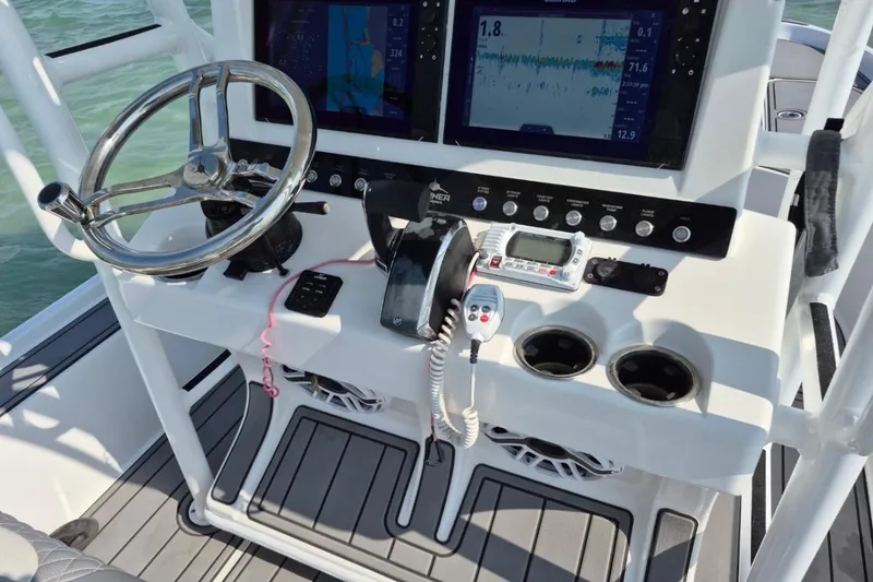 Slide: The Image of 2023 Turner Boatworks 2500VS helm with steering wheel, navigation screens, and control panel. - 8