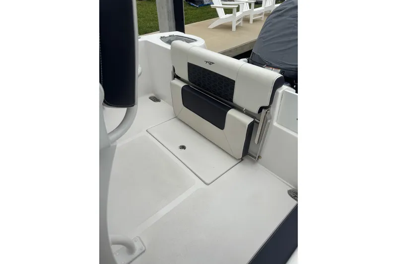 Slide: The Image of 2025 Tidewater 210 CC Adventure boat interior with cushioned seating. - 7