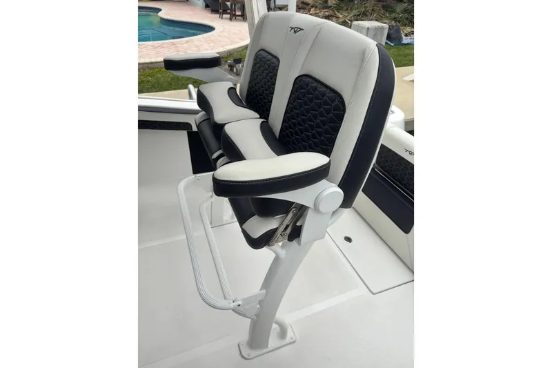 Slide: The Image of 2025 Tidewater 210 CC Adventure boat seat with cushioned armrests and modern design. - 8