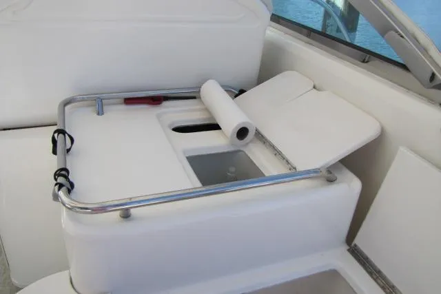 Slide: The Image of 1997 Sea Ray 370 Express Cruiser deck with seating, overlooking calm water. - 11