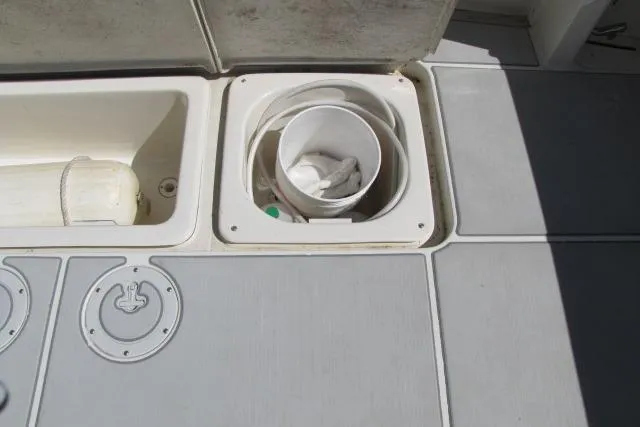 Slide: The Image of 1997 Sea Ray 370 Express Cruiser interior with storage compartment and paper towel holder. - 13