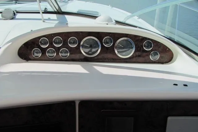 Slide: The Image of 1997 Sea Ray 370 Express Cruiser dashboard with multiple gauges and instruments. - 19