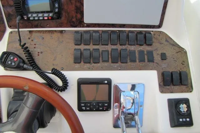 Slide: The Image of Control panel of a 1997 Sea Ray 370 Express Cruiser with switches and navigation equipment. - 20
