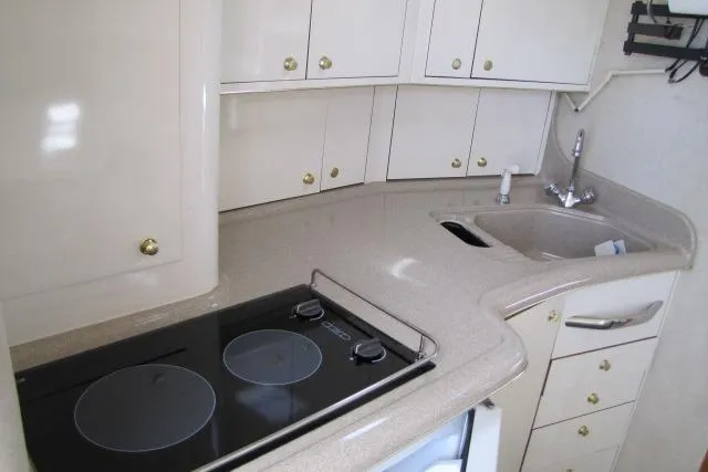 Slide: The Image of Interior of 1997 Sea Ray 370 Express Cruiser with bed, sink, and TV. - 25