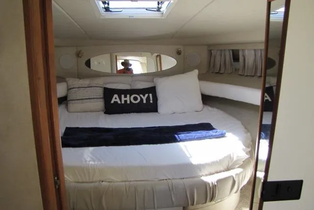 Slide: The Image of Cabinet interior on 1997 Sea Ray 370 Express Cruiser with fan and appliance. - 26