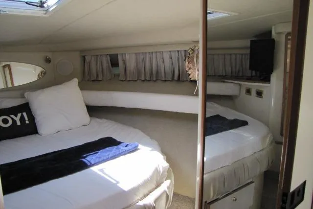 Slide: The Image of Interior cabin of 1997 Sea Ray 370 Express Cruiser with TV and bed. - 27