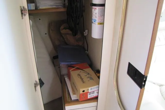 Slide: The Image of 1997 Sea Ray 370 Express Cruiser cabin interior with cozy bed and natural light. - 29