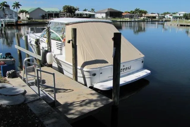 Slide: The Image of 1997 Sea Ray 370 Express Cruiser docked in a serene marina setting. - 3