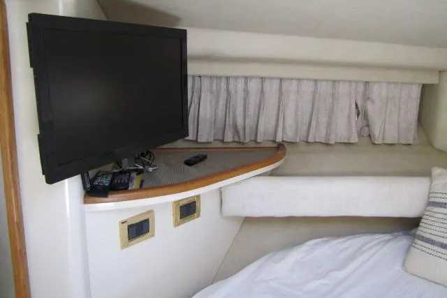 Slide: The Image of Interior of 1997 Sea Ray 370 Express Cruiser with beige seating and table. - 31