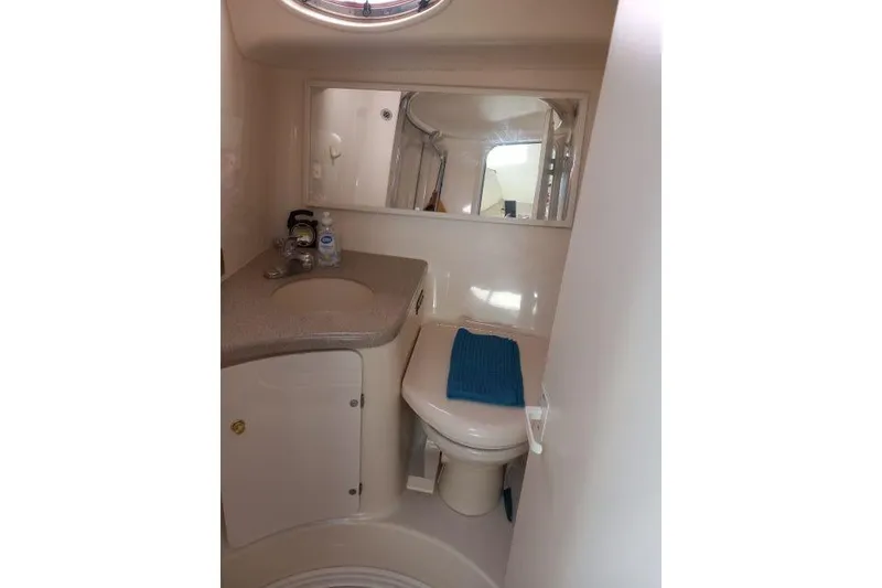 Slide: The Image of Engine compartment of a 1997 Sea Ray 370 Express Cruiser, showcasing mechanical components. - 32