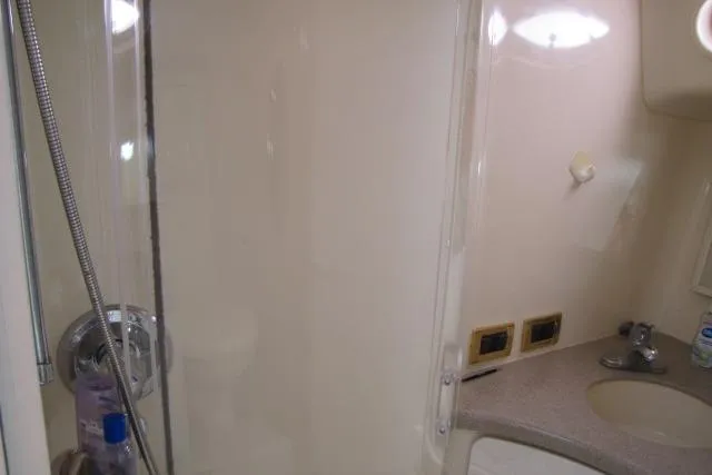 Slide: The Image of Bathroom interior of 1997 Sea Ray 370 Express Cruiser with sink and toilet. - 33