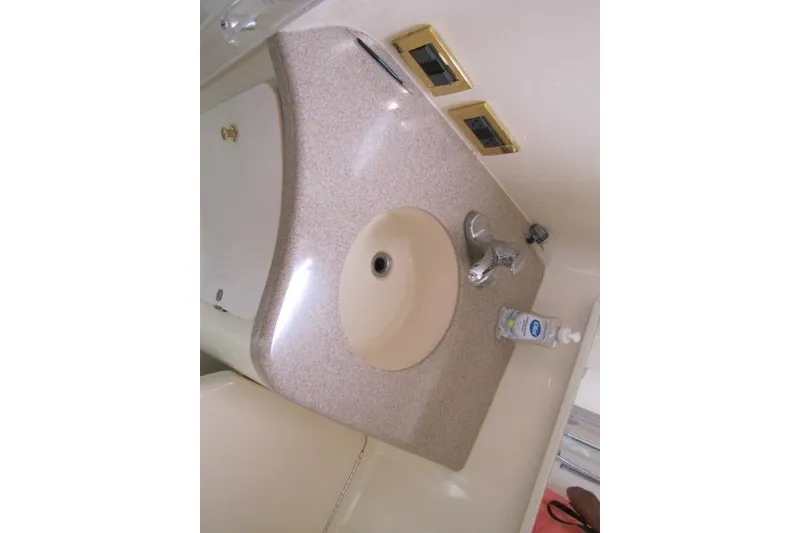 Slide: The Image of Bathroom interior of 1997 Sea Ray 370 Express Cruiser with shower and sink. - 34