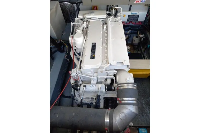 Slide: The Image of Engine compartment of a 1997 Sea Ray 370 Express Cruiser, showcasing a clean, well-maintained engine. - 36