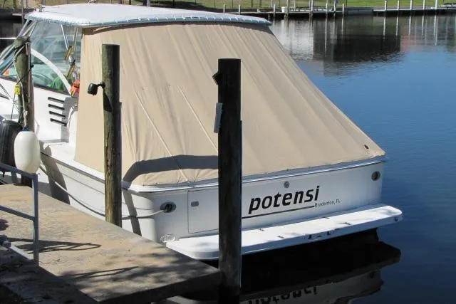 Slide: The Image of 1997 Sea Ray 370 Express Cruiser docked in a serene marina setting. - 4