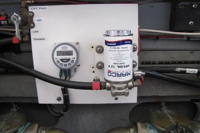 Slide: The Image of Engine compartment of a 1997 Sea Ray 370 Express Cruiser with visible components and battery. - 40