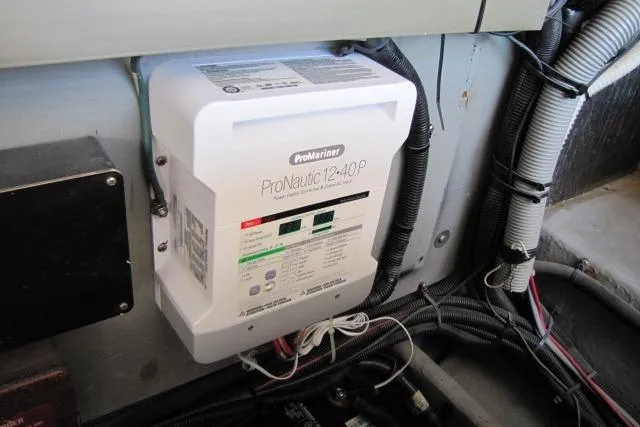 Slide: The Image of Engine room of a 1997 Sea Ray 370 Express Cruiser with various mechanical components. - 42