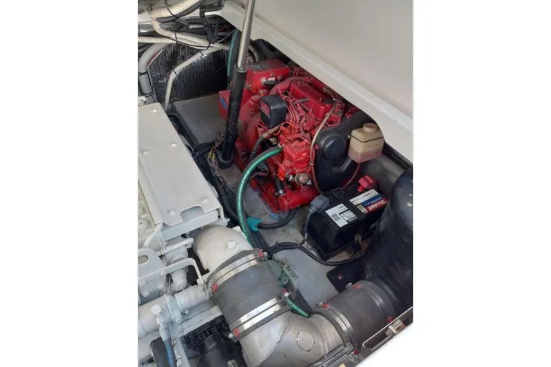 Slide: The Image of Engine room of a 1997 Sea Ray 370 Express Cruiser, showcasing mechanical components and systems. - 53