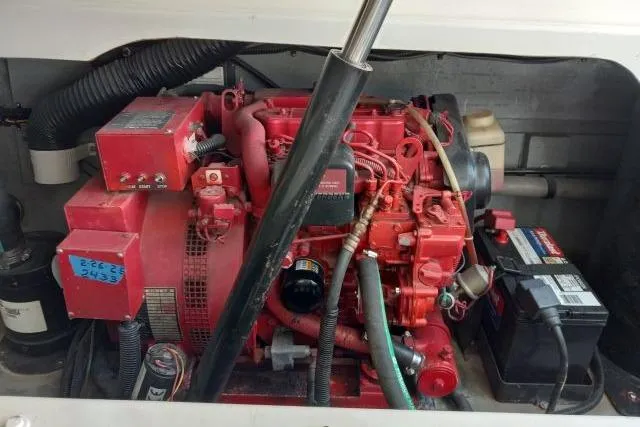 Slide: The Image of Engine compartment of a 1997 Sea Ray 370 Express Cruiser, showcasing mechanical components and wiring. - 54