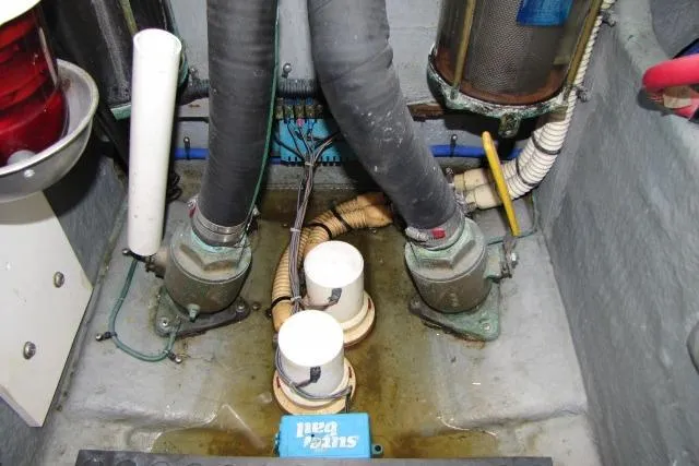 Slide: The Image of Engine room of a 1997 Sea Ray 370 Express Cruiser with electrical components and wiring. - 58